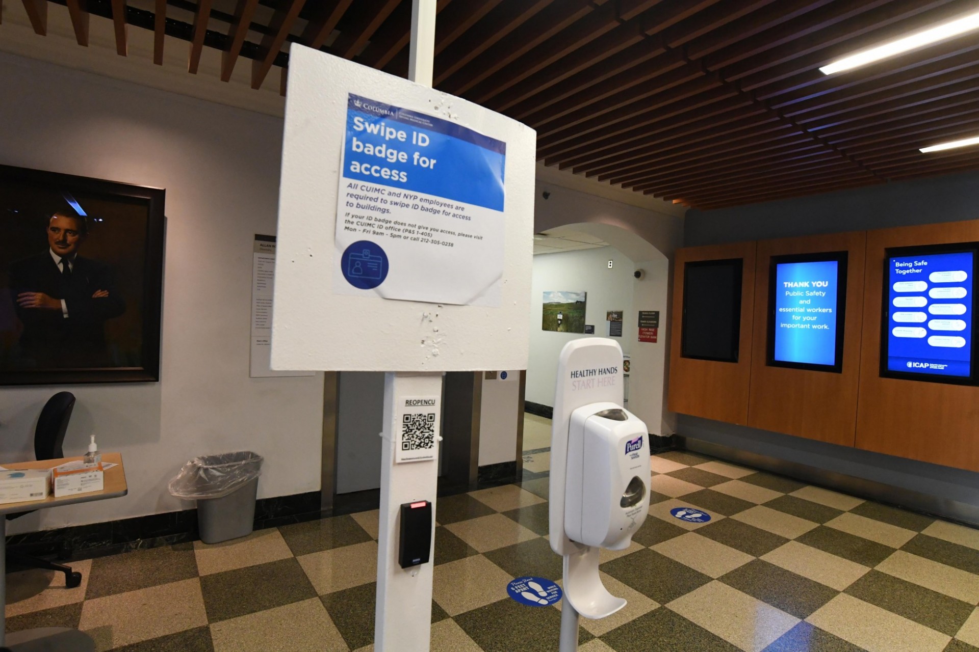 Swipe ID Badge signage and hand sanitizer station at CUIMC