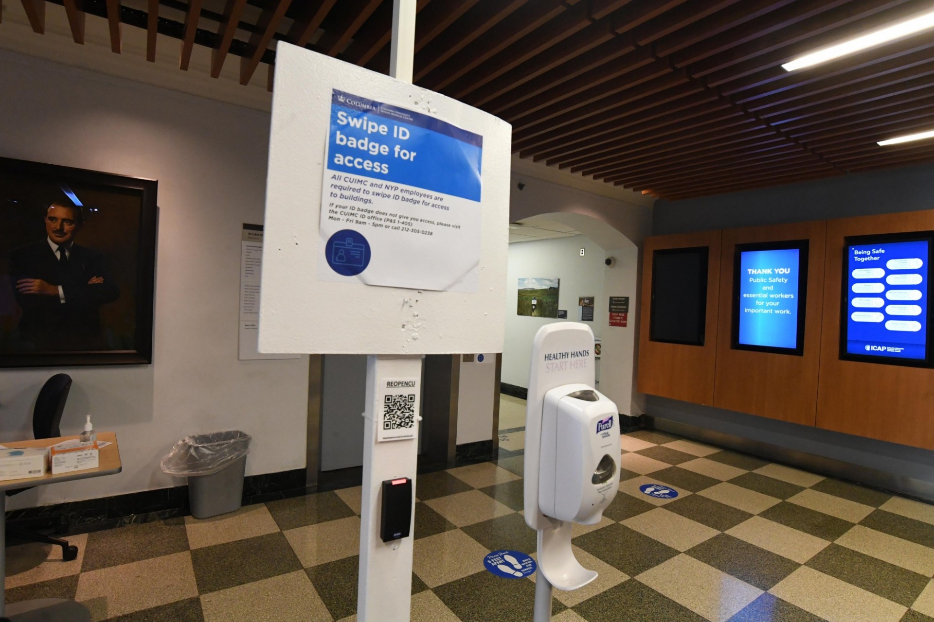Photo by Eileen Barroso Swipe ID Badge signage and hand sanitizer station at CUIMC