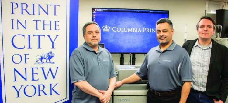 From left: Dan Romanello, Mike Pagan, and Matt Dougherty of Columbia Print portrait of Columbia Print team in the shop in front of Columbia Print logo